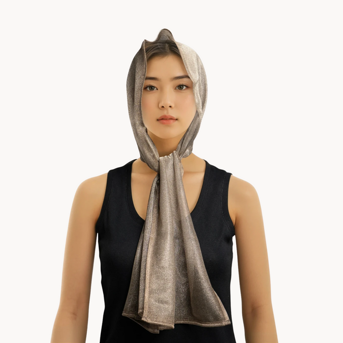 Woman wearing a silver emf 5g shielding headscarf on a white background