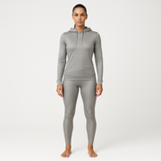 Woman wearing a grey silver gray emf 5g shielding hoodie on a white background